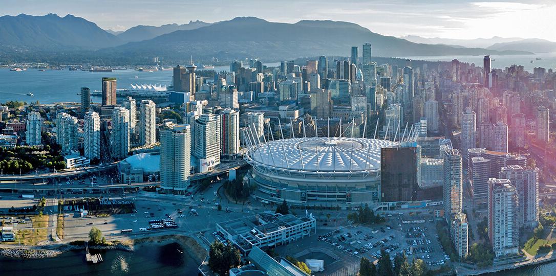 A soccer stadium in the middle of a modern city